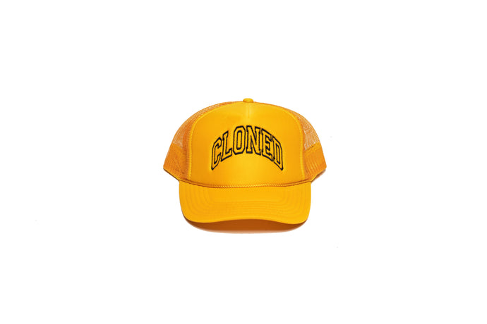 Gold Mesh trucker hat with Cloned embroidered  in black collegiate letters in an Arc across the front panels, front view.