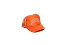 Load image into Gallery viewer, Orange Mesh trucker hat with Cloned embroidered in white collegiate letters in an Arc across the front panels, diagonal view.