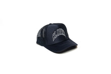Load image into Gallery viewer, Black Mesh trucker hat with Cloned embroidered  in collegiate letters in an Arc across the front panels, diagonal view.