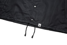 Load image into Gallery viewer, Coach Jacket with White Logo, Black, Front View of the bottom hem tag, waist draw string and buttons.
